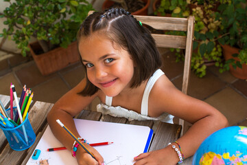 Girl Back To School.
Little Girl Doing Homework In The Courtyard Of Her House. 6-year-Old Girl With...