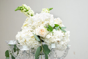 Natural bouquet of white flowers on top of a centerpiece. 