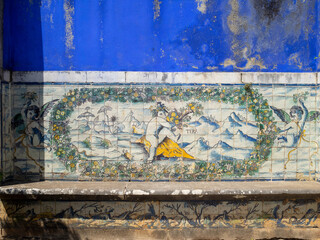 Old garden bench with tiles allegory to the earth