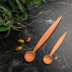 wooden spoons on the table with olives