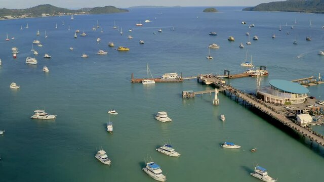 Aerial view of the marina lot. Docked sailboats and catamarans in yacht club. Lack of tourists due to lockdown of tropical countries. The consequences of coronavirus for the tourism business.