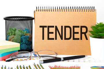 Word TENDER on notebook, glasses, sticker, chart, diagram.
