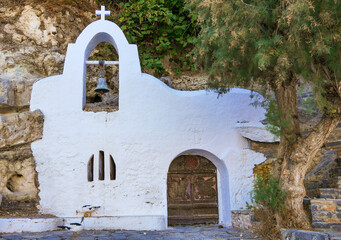 Little chapel whith bell and wooden door, Crete, Greece