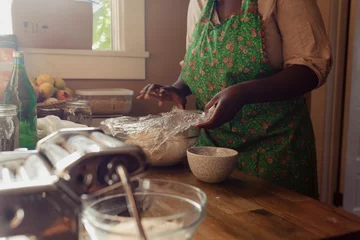 Foto op Canvas Home baker covering bread dough inside of a home kitchen © Oriana Koren