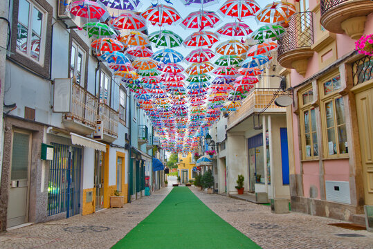 Colorful umbrellas in the street during the Agit&aacute;gueda street festival in &Aacute;gueda, Portugal