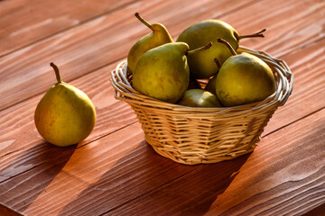 Healthy Organic Pears in the Basket on wooden rustic background. Fresh pears from the farm. Healthy food full of vitamins