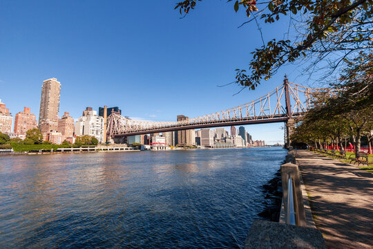 A picture of Ed Koch Queensboro Bridge in New York City, USA. In the picture one can see the East River, the Roosevelt island and Manhattan skyline