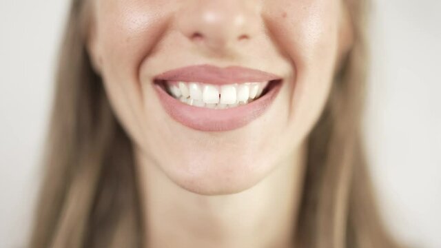 Close up of smiling teeth isolated. Detail of a smile woman. Young successful girl is smiling. Dentistry and teeth whitening concept