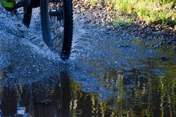 Mountain bike wheel riding through stream
