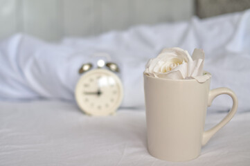 white alarm clock in bedroom at home in the moning,time to wake up, time is money