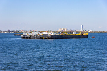 A boat shipping cargo between New York and New Jersey, USA