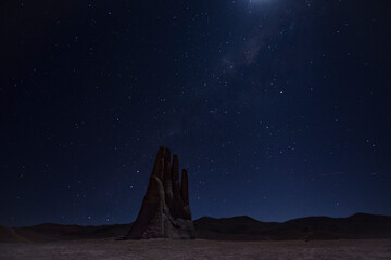 Hand of the desert in Antofagasta, Chile. Night long exposure shot with sky full of stars....