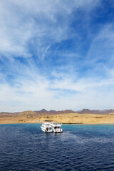 Motor yachts and snorkeling tourists in Ras Muhammad National Park, Sharm el Sheikh, Egypt - 449264549
