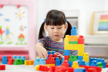  young girl playing creative toy blocks for homeschooling