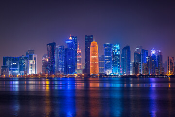 Fototapeta premium Illuminated skyline of Doha at night, Qatar, Middle East.