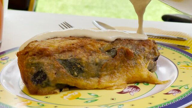 Walnut sauce covering a traditional mexican chili called "Chile Poblano"