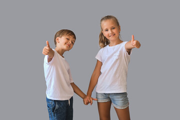 Cute two kids, little boy and girl in white t-shirts