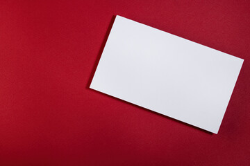 A white postcard on a red background. An empty space for the text.