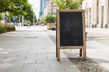 Empty sandwich chalkboard stand on a street ready to be filled