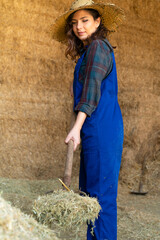 Full length portrait of young farmer in ranch with shovel