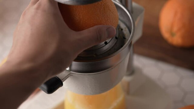 making fresh orange juice with squeezer