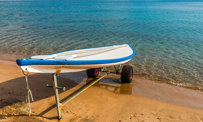 Morning at sandy beach of the Red Sea with rescue kayak boat, Middle East