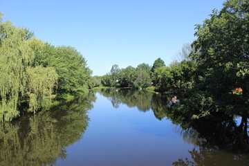 Fototapeta na wymiar Reflection on Pike River in Notre-Dame-de-Stanbridge, Quebec