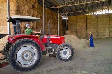 Man riding tractor to the hayloft