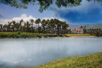 Fototapeta na wymiar lake in Hualien, Taiwan. There are blue sky, white clouds, trees, shadows, and flowing water.