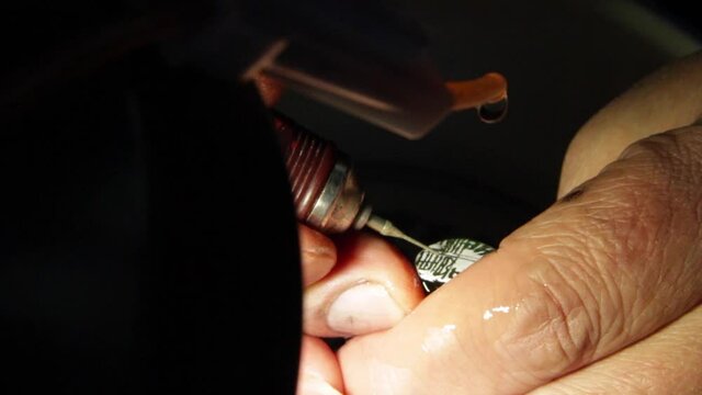 Close-up of a skilled craftsman carving an emblem stamp in Guangzhou, China.