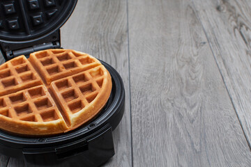 freshly made waffle in an open waffle iron