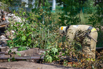 A firefighter cleans up the ruins after the fire and explosion.