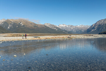 Hikers walking along riverside