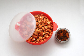 Chili Covered Popcorn Made in Red Microwave Container
