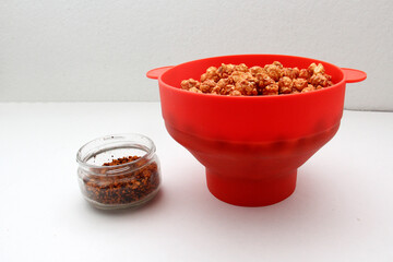Chili Covered Popcorn Made in Red Microwave Container
