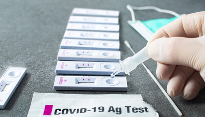 Drop nasal sample into rapid antigen test stick.PCR rantigen test