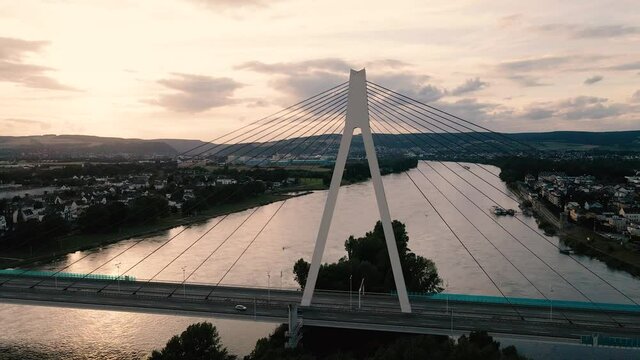 Slowly zooming out aerial side view of Raiffeisenbrucke bridge between Neuwied and Wei&szlig;enthurm across Rhine river, Germany.