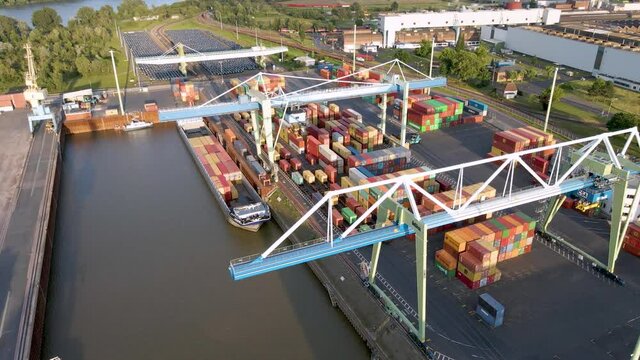 4K drone clip landing over shipping containers over a river and an industrial complex in Andernach port in Germany