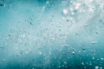 Underwater View of Bubbles In Deep Blue Ocean. Close Up Water. Background