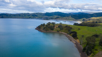 Naklejka na ściany i meble Aerial View of Waitawa Regional Park, Beach, Pier, Deck Green Trees and Cliff in New Zealand - Auckland Area
