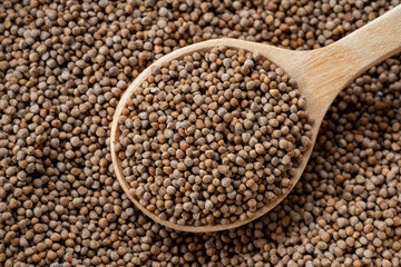 Close-up Perilla seeds in a wooden spoon are grains that can be eaten with both seeds and leaves. It can be found in the northern part of Thailand, top view.