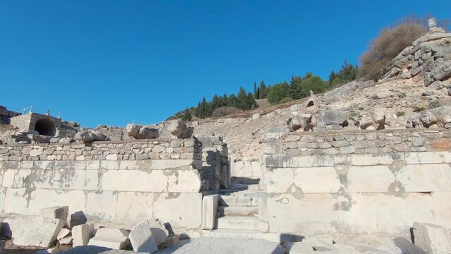 Walk through broken columns entering the Odeon amphitheater in ancient city Ephesus.