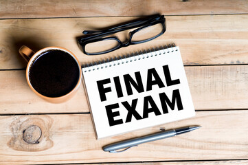 FINAL EXAM text on a notebook with cup of coffee