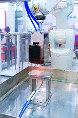 robot arm polishing the mobile phone part in the production line.
