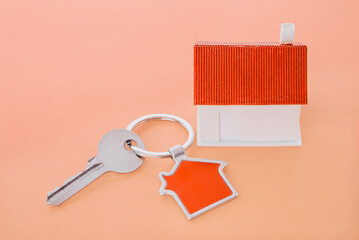 key chain with house symbol and keys on wooden background,Real estate concept