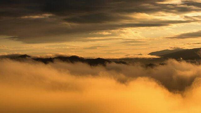 Timelapse video 4k, Aerial view Beautiful of morning scenery Golden light sunrise And the mist flows on high mountains, Wonder fog.