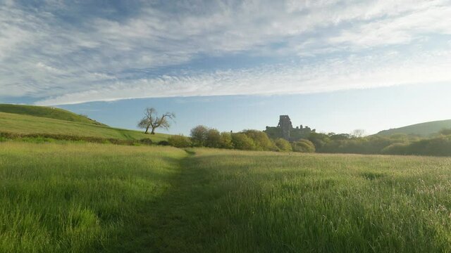 Corfe Castle on a summer's morning, slow zoom in.