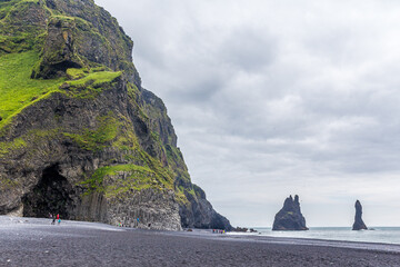 The black sand beach of Reynisfjara and the mount Reynisfjall from the Dyrholaey promontory in the...