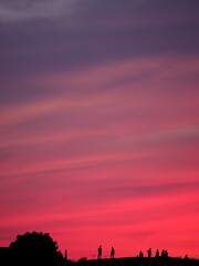 Tokyo,Japan - August 5, 2021: Silhouette of the people watching the red sky at sunset on the hill
