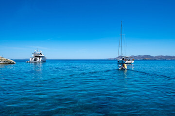 Obraz premium Milos island, Adamas port, Cyclades Greece. Moored boats buildings background.